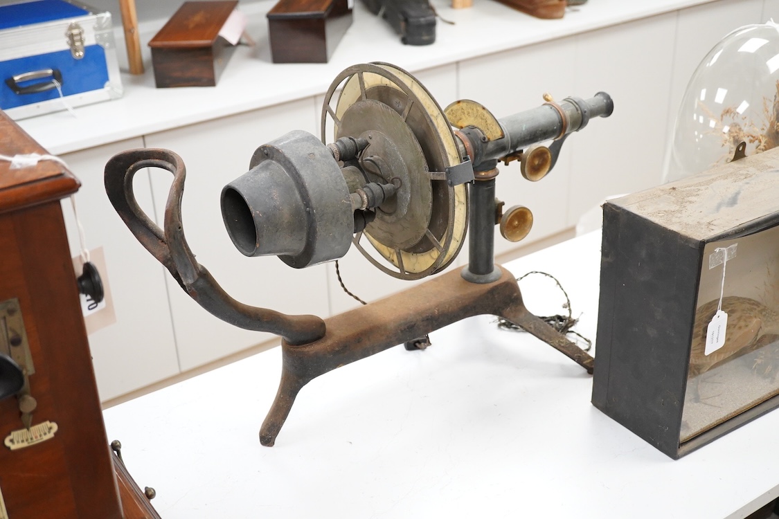 An early 20th century ophthalmic keratometer, designed to allow opticians to establish the curvature of a patient’s eye, constructed of cast-iron, brass and tin, and fitted with electric lamps and early celluloid scales,